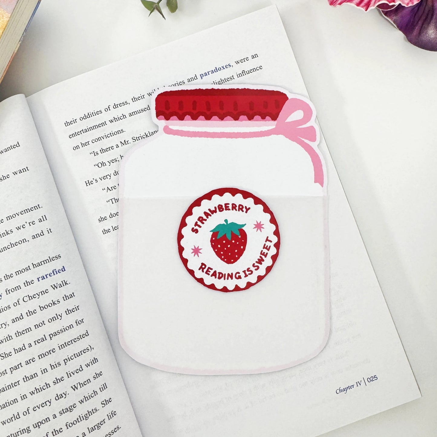 Empty Strawberry Jar backing card with a pink bow and Reading is Sweet label displayed on an open book