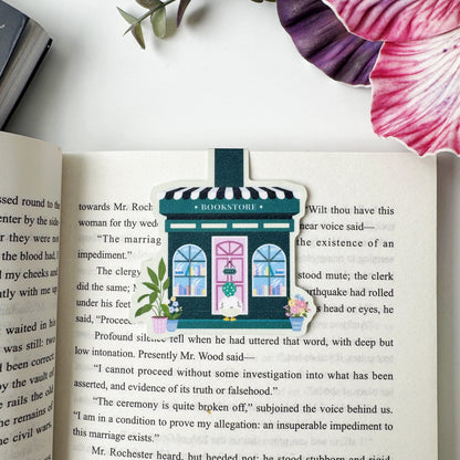 Duck's Little Bookshop magnetic bookmark clipped over a page of an open book