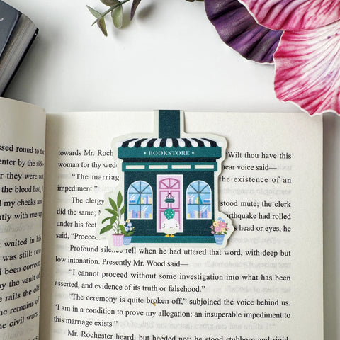 Duck's Little Bookshop magnetic bookmark clipped over a page of an open book