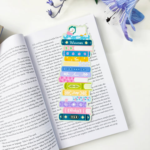 Colorful book stack classic bookmark resting on an open book, with a duck and the words Wherever You Are Keep Reading