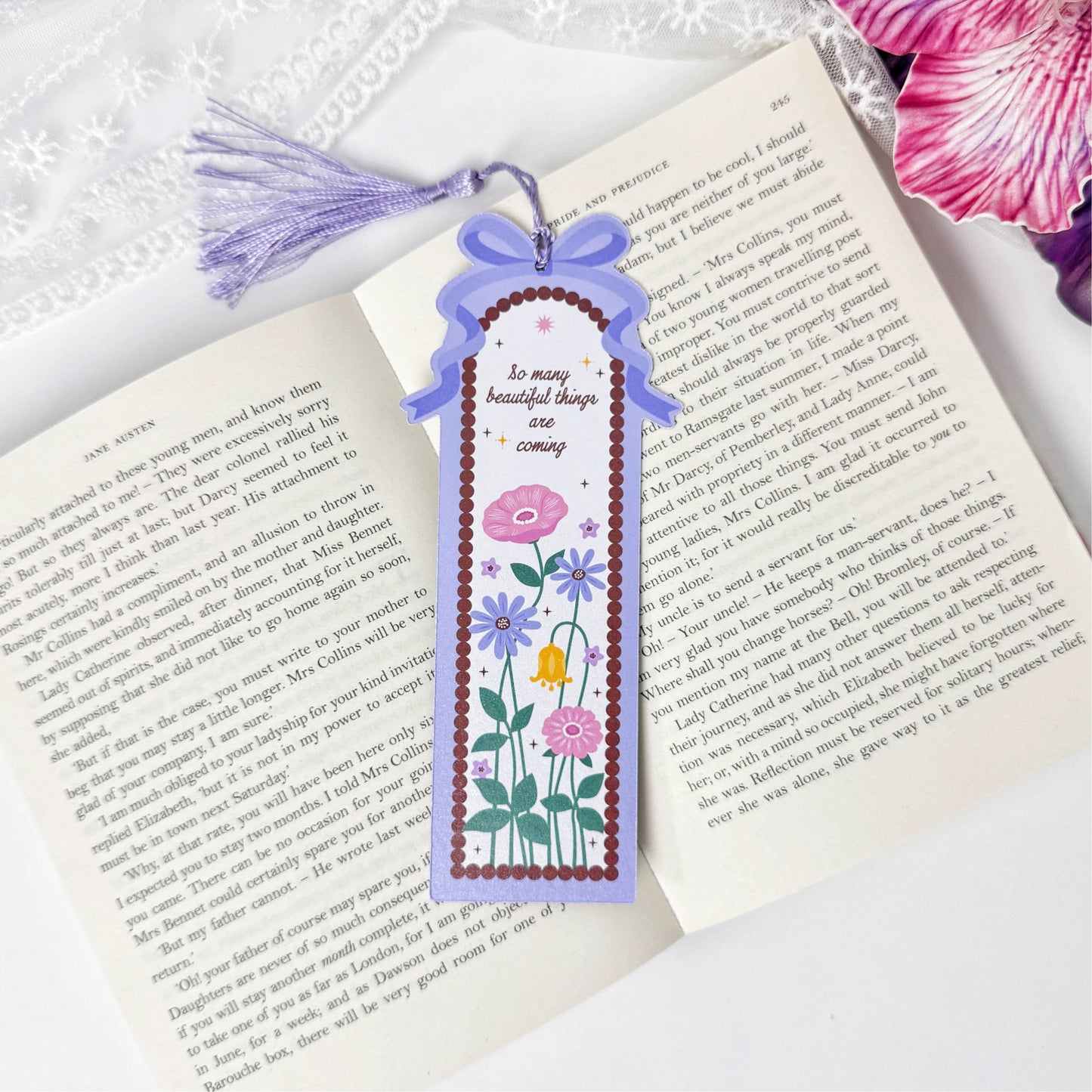 Blooming Garden floral tassel bookmark displayed on an open book