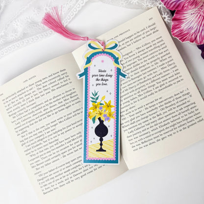 Golden Vase floral tassel bookmark displayed on an open book