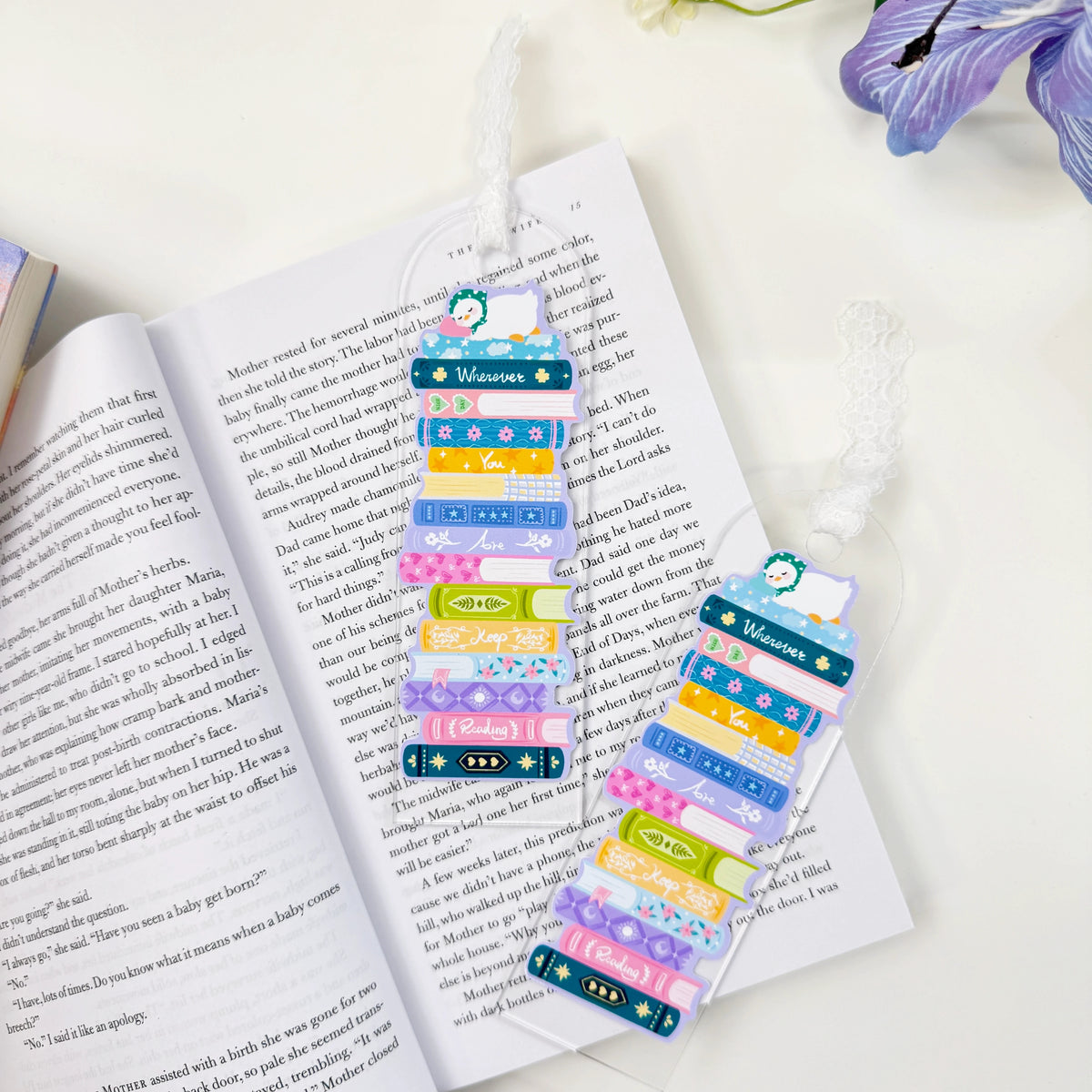Two examples of the Wherever You Are acrylic book stack bookmark with white lace ties, sold individually