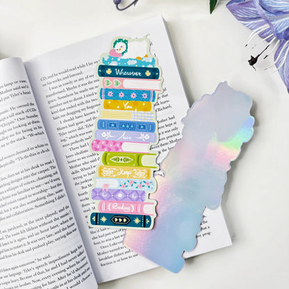 Front and silver holographic back of the Wherever You Are book stack classic bookmark on an open book