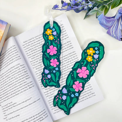 Garden in Bloom floral acrylic bookmark with lace beside matching floral artwork on an open book