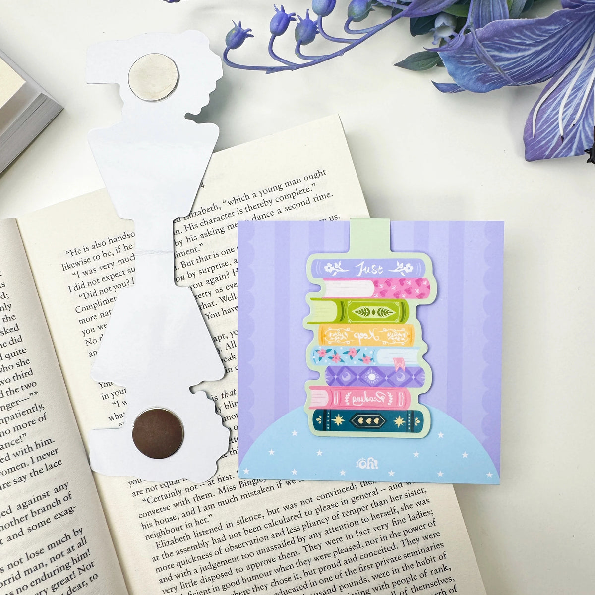Front and back pieces of the Just Keep Reading book stack magnetic bookmark showing the round magnets