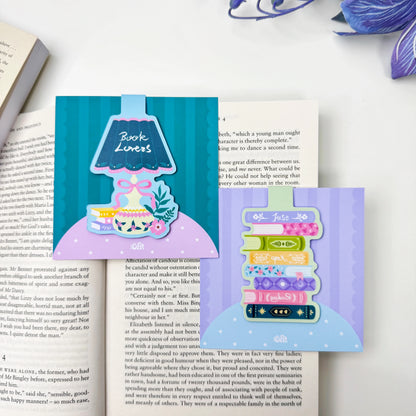 Book Lovers lamp and Just Keep Reading book stack magnetic bookmarks, each sold separately, displayed on an open book