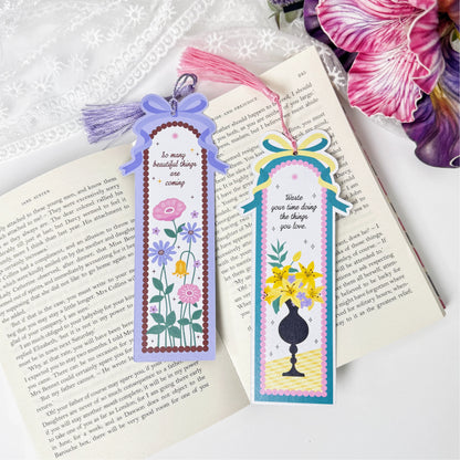 Blooming Garden and Golden Vase tassel bookmarks displayed on an open book