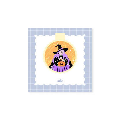 Purple Witch holographic magnetic bookmark with a purple-haired witch holding an orange jack-o'-lantern bucket