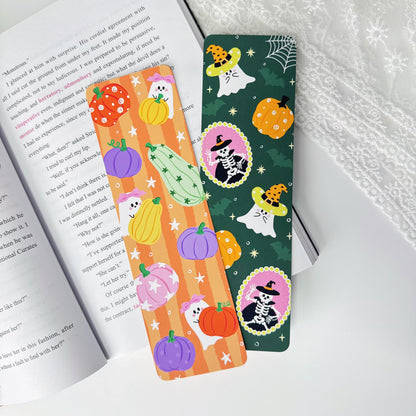 Two Halloween classic bookmarks displayed together on an open book