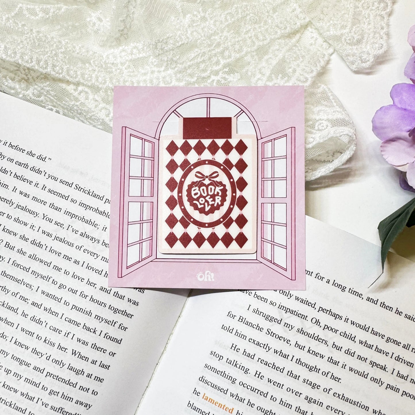Red Diamond Book Club magnetic bookmark clipped on a book page