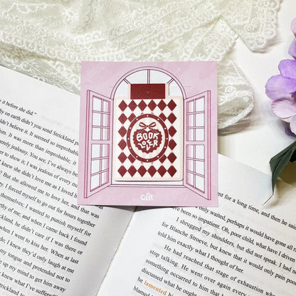 Red Diamond Book Club magnetic bookmark clipped on a book page