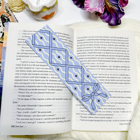 Blue wavy bow classic bookmark displayed on an open book page