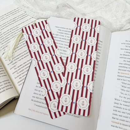 Burgundy stripe rose tassel bookmark displayed with coordinating tassel