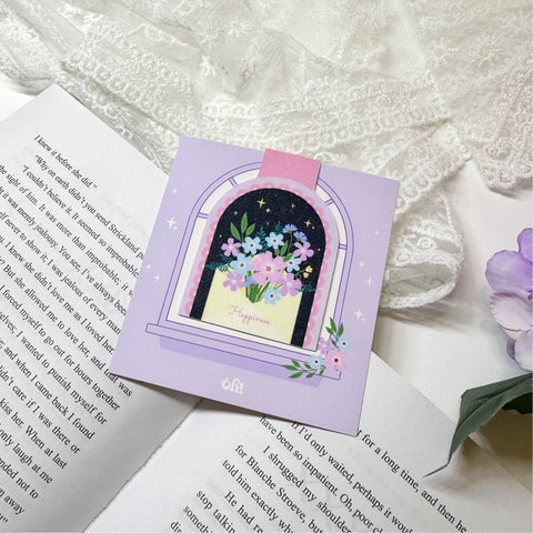 Floral window sparkly magnetic bookmark displayed on an open book
