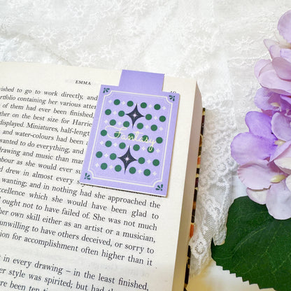 Front and back view of Purple Magic Book magnetic bookmark
